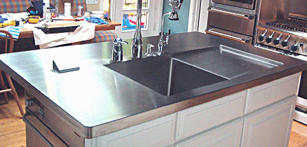 Kitchen island with stainless steel countertop and sink