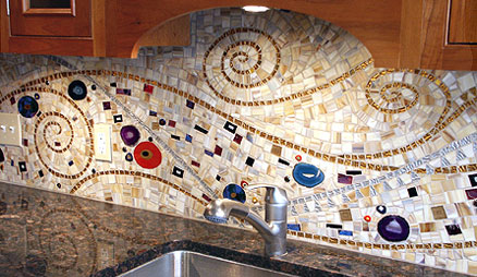 Mosaic backsplash made by mixing and matching varying materials of different sizes, shapes, colors, and textures