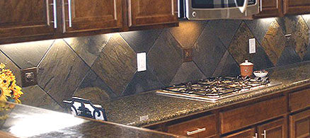 Slate backsplash in the form of large tiles set on a diagonal