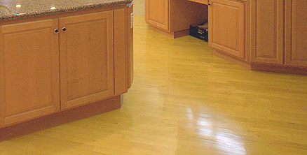 White maple flooring in a kitchen with maple cabinets