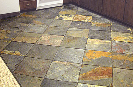 Slate flooring in the form of square tiles with different patterns