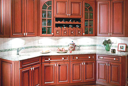 Cherry kitchen cabinets with light countertops and backsplashes