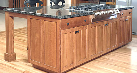 Kitchen island with wood cabinets and stone countertop