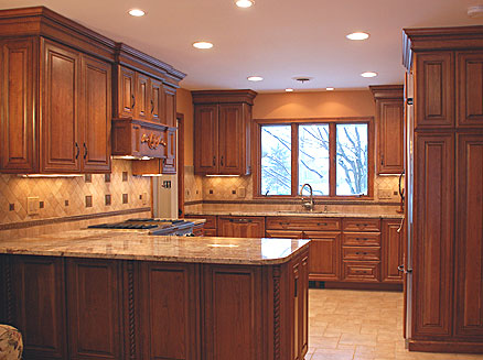 Red birch kitchen cabinets in combination with light-colored granite countertops, tile backsplash and floor