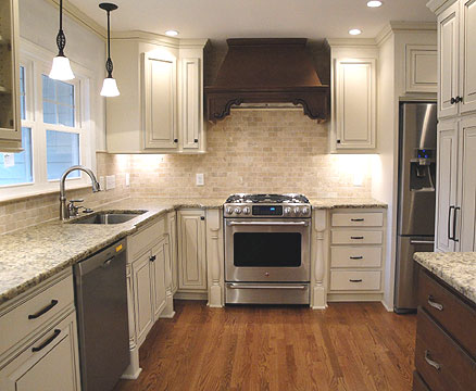 French country kitchen design - white cabinets in combination with granite counters, marble tile backsplashes, stainless steel appliances and a wooden floor