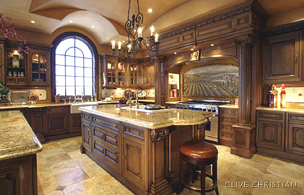 Luxury kitchen design idea - custom-made wood cabinets in combination with natural stone countertops, stainless steel appliances and tile flooring