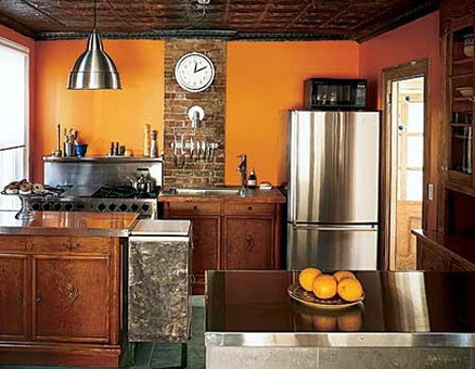 Balance stainless steel, textured cabinets, brick and bright-colored walls