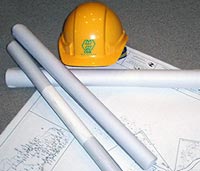 Photo of helmet over plans for remodeling