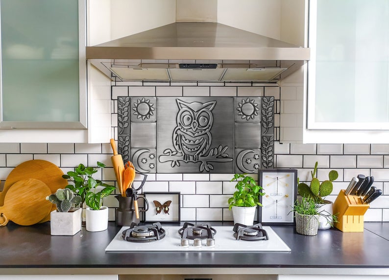 Stainless steel backsplash representing owl on a branch