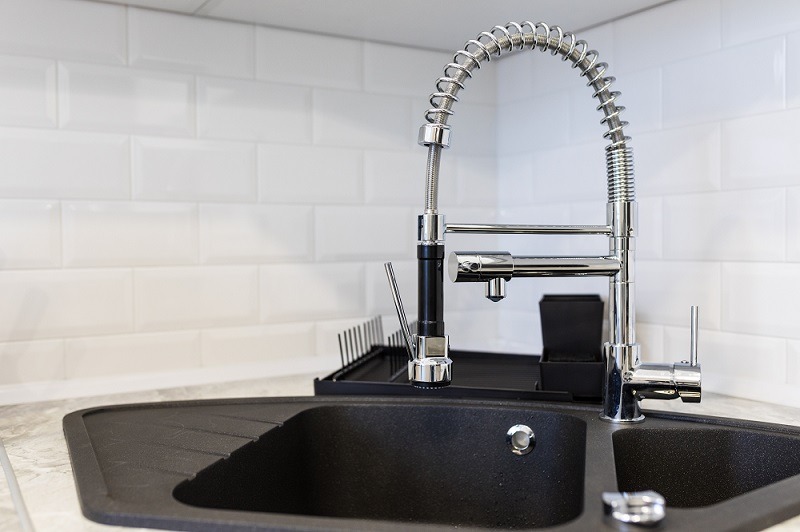 Shiny stainless steel faucet with chrome water tap.